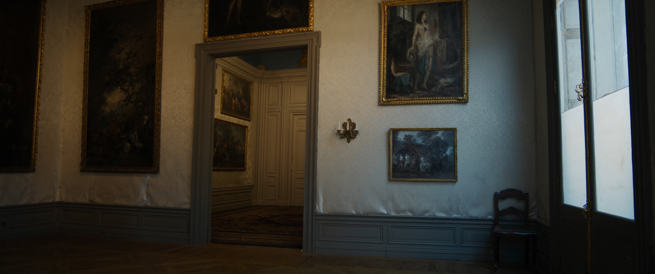 An empty gallery room in a Parisian hôtel particulier, morning light from the right